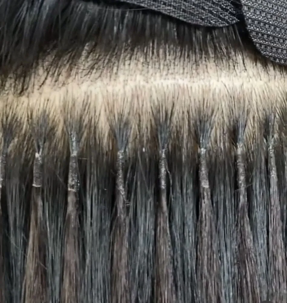 A row of hand-tied BELLAMI wefts installed seamlessly at the root — real extension work at The Beauty Suite.