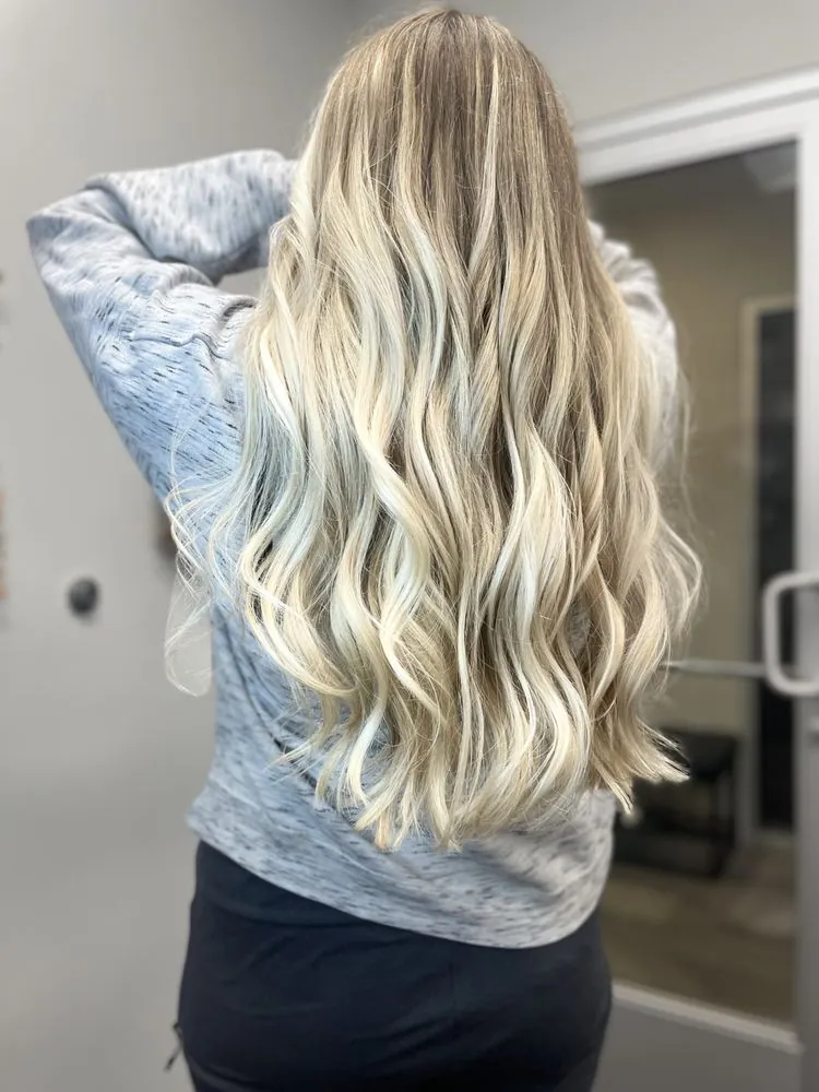Bright blonde waves with a soft rooted grow-out, finished at The Beauty Suite.