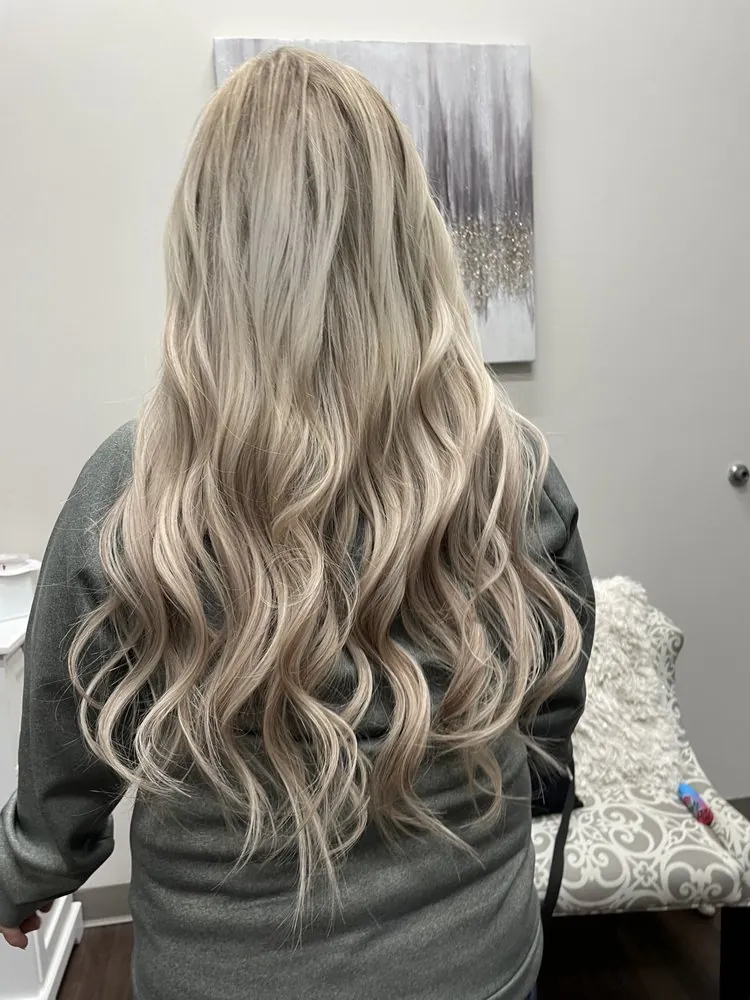 Beige-blonde long waves with dimensional lift, finished at The Beauty Suite.