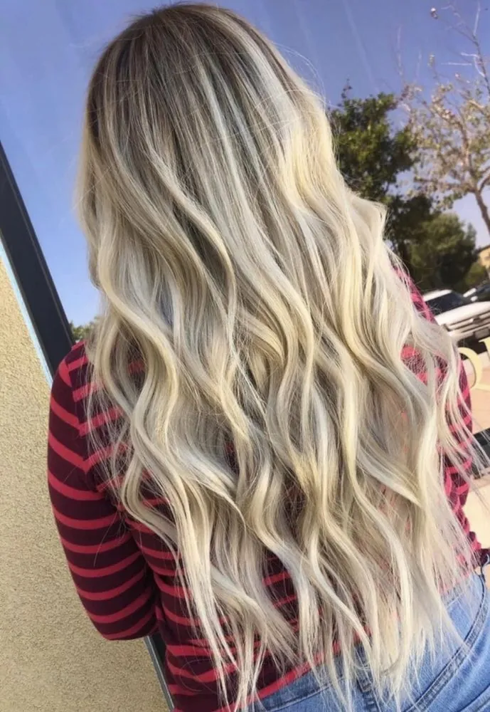 Luminous platinum-blonde waves in daylight, finished at The Beauty Suite.