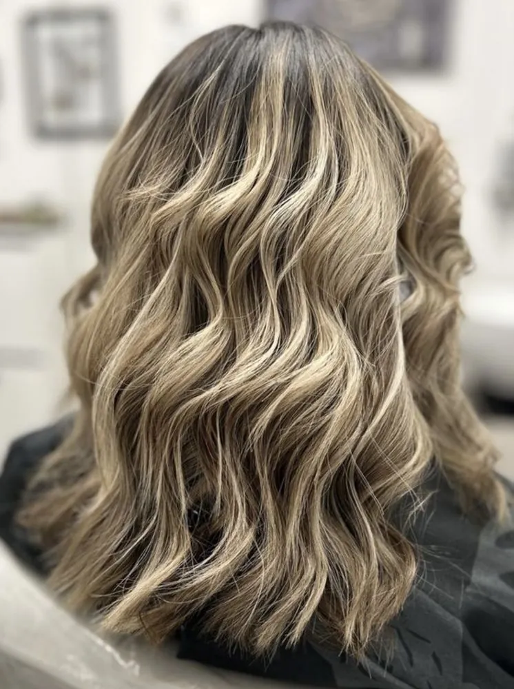 Warm bronde balayage lob with natural dimension, finished at The Beauty Suite.
